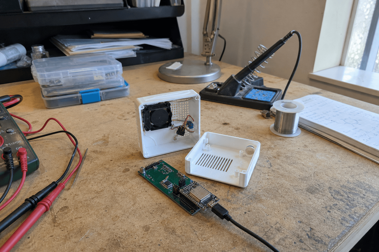 Aeroshi connected environmental monitor opened on an electronics workbench